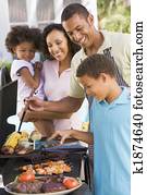 Family Enjoying A Barbeque Family Enjoying A Barbeque