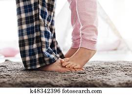 Adorable young girl dancing with her dad