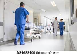 Doctors Hospital Corridor Nurse Pushing Gurney Stretcher Bed