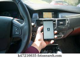 Driver starting uber application with new logo Driver starting uber application with new logo