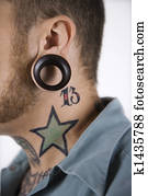 Man with tattoos and piercings.