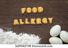 Letter biscuits word FOOD ALLERGY on kitchen table background Letter biscuits word FOOD ALLERGY on kitchen table background