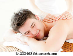 Relaxed young man receiving a back massage 