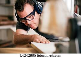 Carpenter using electric saw Carpenter using electric saw