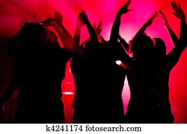 People dancing in club with laser