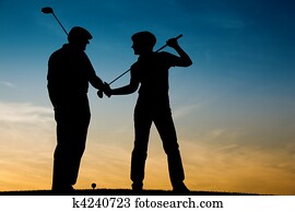 Senior couple playing Golf at sunse Senior couple playing Golf at sunse