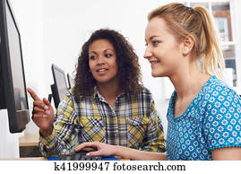 Businesswoman Giving Computer Training In Office