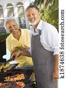 Couple Cooking On A Barbeque Couple Cooking On A Barbeque
