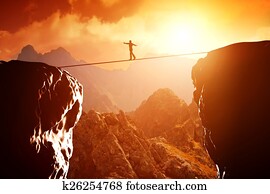 Man walking and balancing on rope