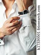 Sexy man buttons cuff-link on French cuffs