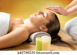Woman receiving reiki treatment on forehead. Woman receiving reiki treatment on forehead.
