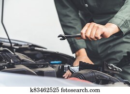 Professional mechanic hand providing car repair and maintenance service Professional mechanic hand providing car repair and maintenance service