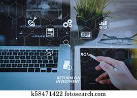 businessman hand working stylus pen and digital tablet computer and memo note and laptop computer. Digital business strategy layer effect. Attending video conference in modern office.On wooden desk, Photo close up exposure effect