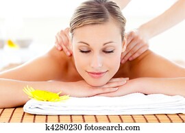 Portrait of a delighted woman lying on a massage table Portrait of a delighted woman lying on a massage table