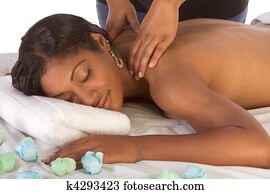 African-American woman getting massage in spa African-American woman getting massage in spa