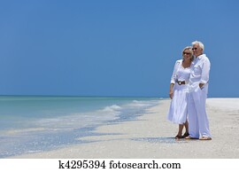 Happy Senior Couple Looking To Sea on A Tropical Beach Happy Senior Couple Looking To Sea on A Tropical Beach
