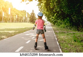 Little girl roller skating in park Little girl roller skating in park