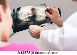Dentist explaining x-ray to patient
