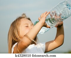 Kid drinking bottled water Kid drinking bottled water