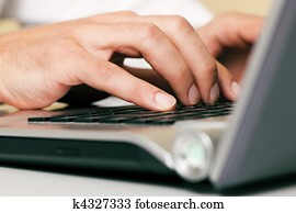 Man typing computer keyboard