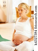 Pregnant woman doing pregnancy yoga Pregnant woman doing pregnancy yoga
