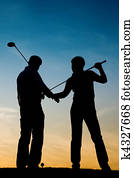 Senior couple playing Golf at sunset Senior couple playing Golf at sunset