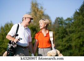 Senior couple playing Golf Senior couple playing Golf
