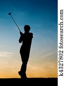 Senior female golf player at sunset Senior female golf player at sunset