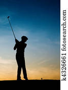 Senior female golf player at sunset Senior female golf player at sunset