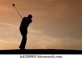 Senior male golf player at sunset Senior male golf player at sunset