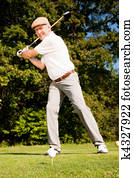 Senior player golf teeing Senior player golf teeing