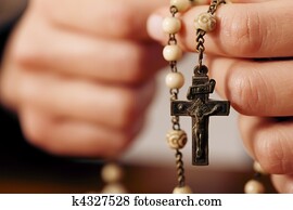 Woman praying with rosary to God