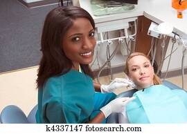 Caucasian woman and African-American dentist