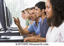 Teacher assisting college student in a computer lab Teacher assisting college student in a computer lab