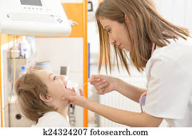 Cute boy being checked in throat