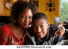 African-American woman with young man in kitchen African-American woman with young man in kitchen