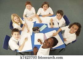 Overhead View Of Schoolchildren Working Together At Desk