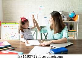 Mom and girl enjoying homeschool together Mom and girl enjoying homeschool together