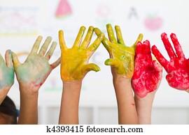 kids hands covered with paint kids hands covered with paint