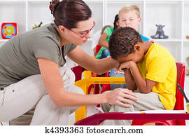 teacher comforting crying boy teacher comforting crying boy
