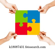 four hands connecting puzzle pieces