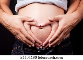 Love hands of pregnant woman and husband