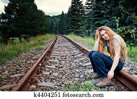 Sad suicidal lonely woman on railway track