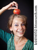 Woman with healthy teeth and apple on head