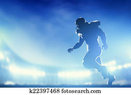 American football players in game, running. Stadium lights American football players in game, running. Stadium lights