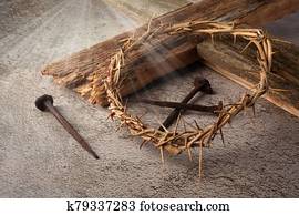 Easter background depicting the crucifixion with a rustic wooden cross, crown of thorns and nails.