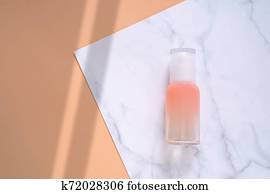 Flat lay of skincare product on marble and orange background in minimal style with shadow shape, beauty and health care product Flat lay of skincare product on marble and orange background in minimal style with shadow shape, beauty and health care product