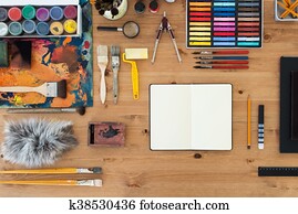 Painter workplace top view. Wooden table of an artist with art tools for drawing.