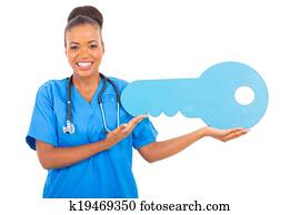 african medical intern doctor holding a toy key african medical intern doctor holding a toy key
