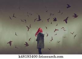 woman with red hair standing among birds woman with red hair standing among birds
